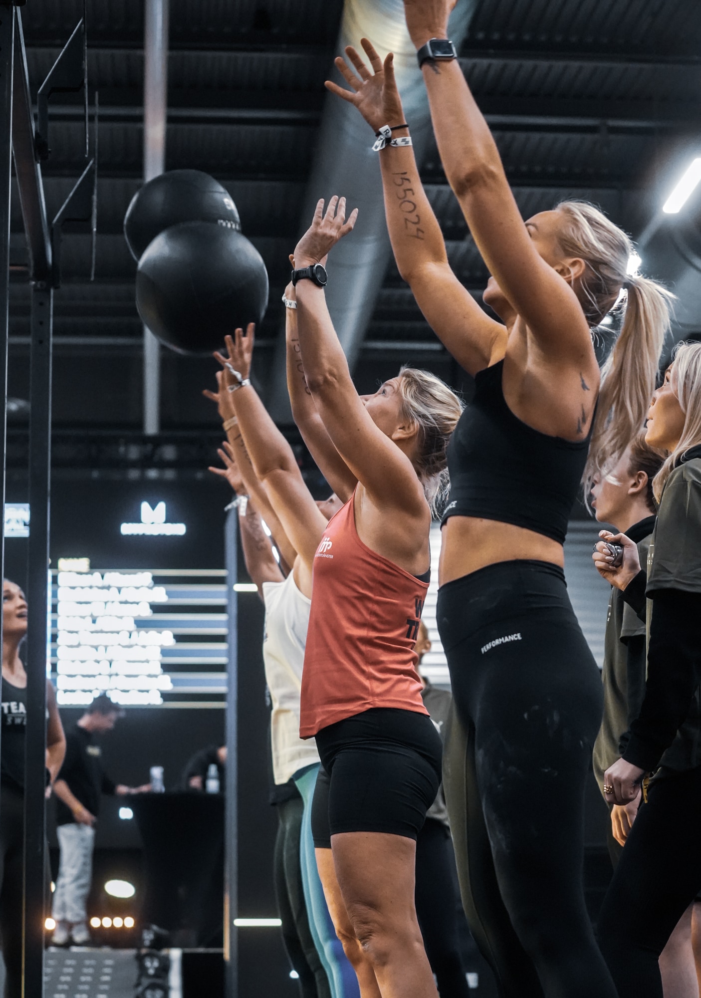 Women on SkiErg in Hyrox competition