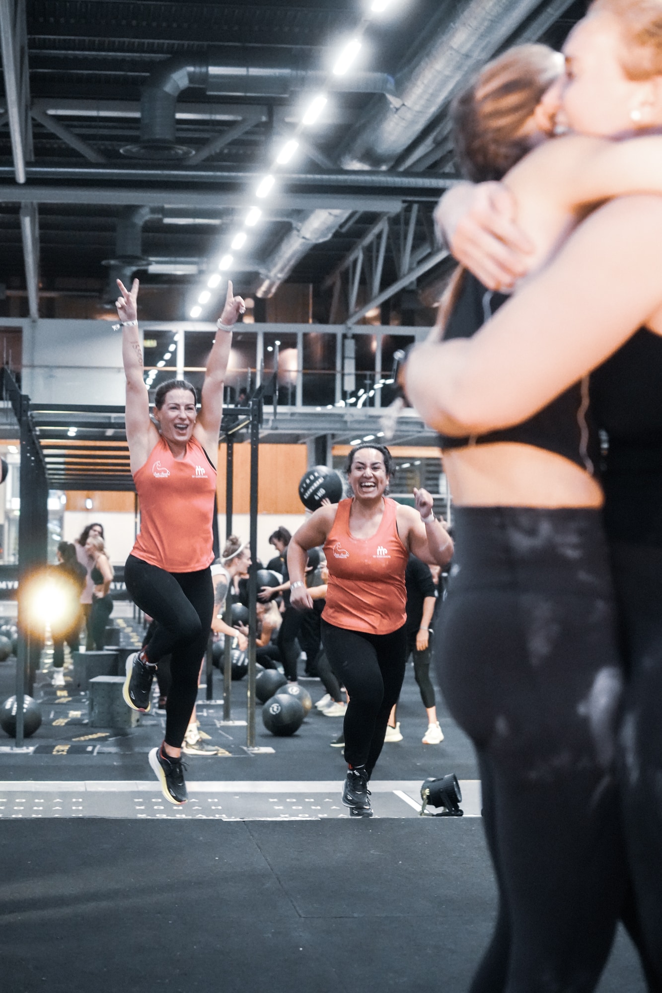 People hugging at a Hyrox competition