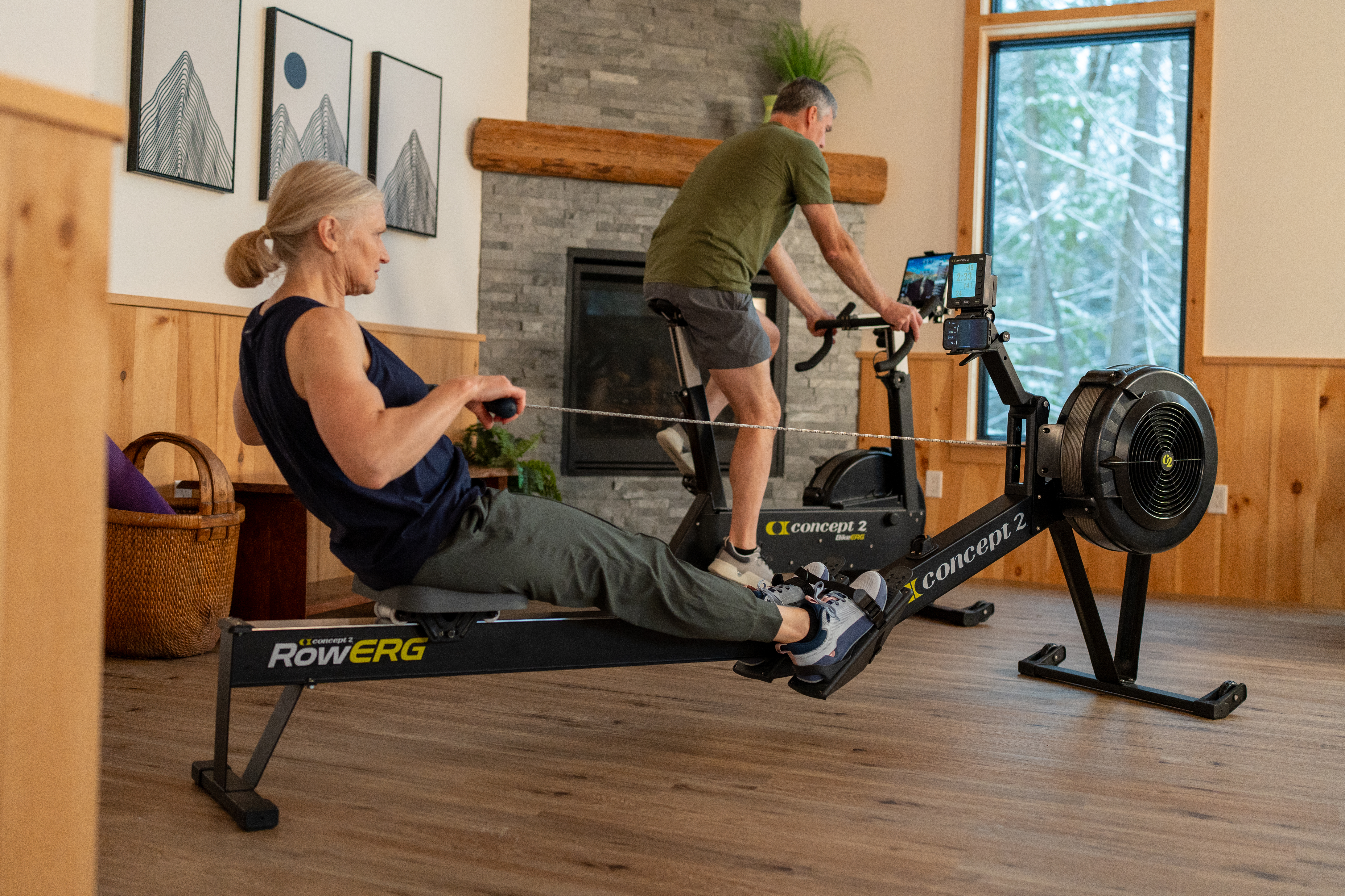 Man and Woman on BikeErg and RowErg in home